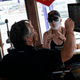 A restaurant guest wears a facemask with Dr. Anthony Fauci, director of the National Institute of Allergy and Infectious Diseases, as Fish Tails bar and grill opens for in-person dining, amid the coronavirus pandemic, on May 29, 2020 in Ocean City, Maryland